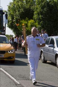 Travis Perkins Duo Carry the Olympic Flame in Recognition of Charity Achievements